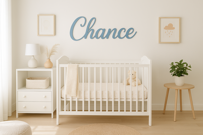 Nursery room with a white crib, nightstand, and wall decor.